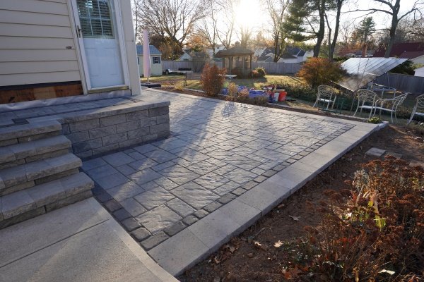 Stylish and durable Techo-Bloc paver patio installed by AQ Masonry, showcasing intricate patterns and robust construction, ideal for enhancing outdoor living spaces