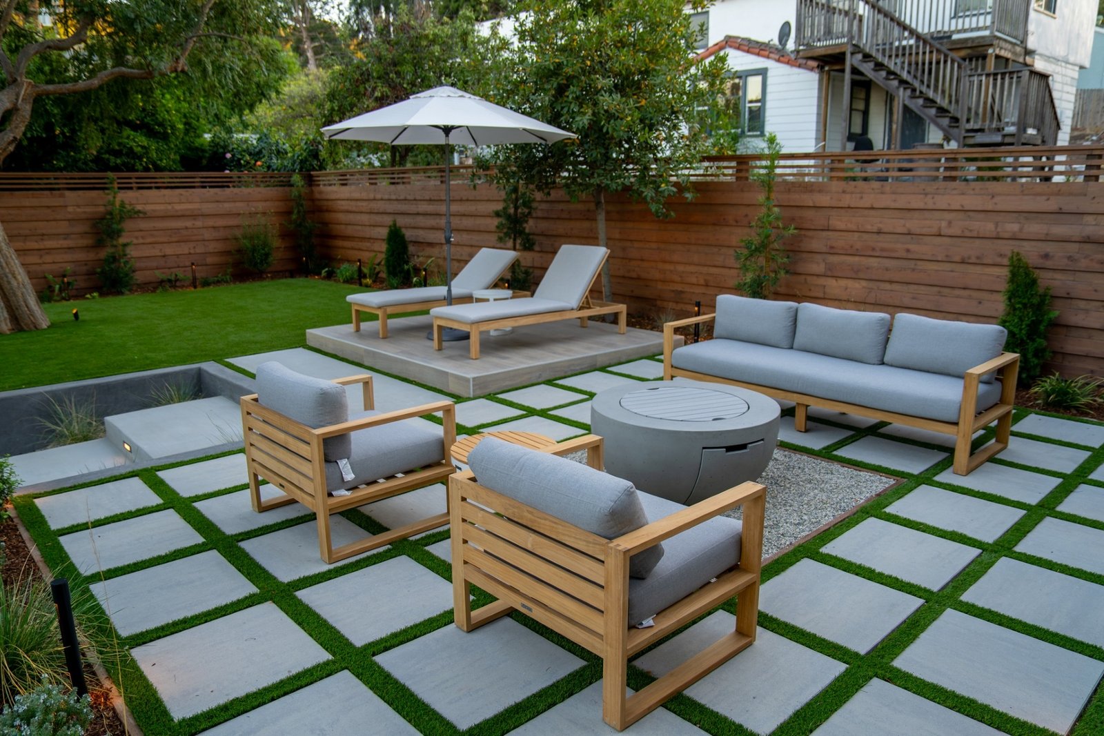 3D design rendering of a large-format paver patio with outdoor furniture