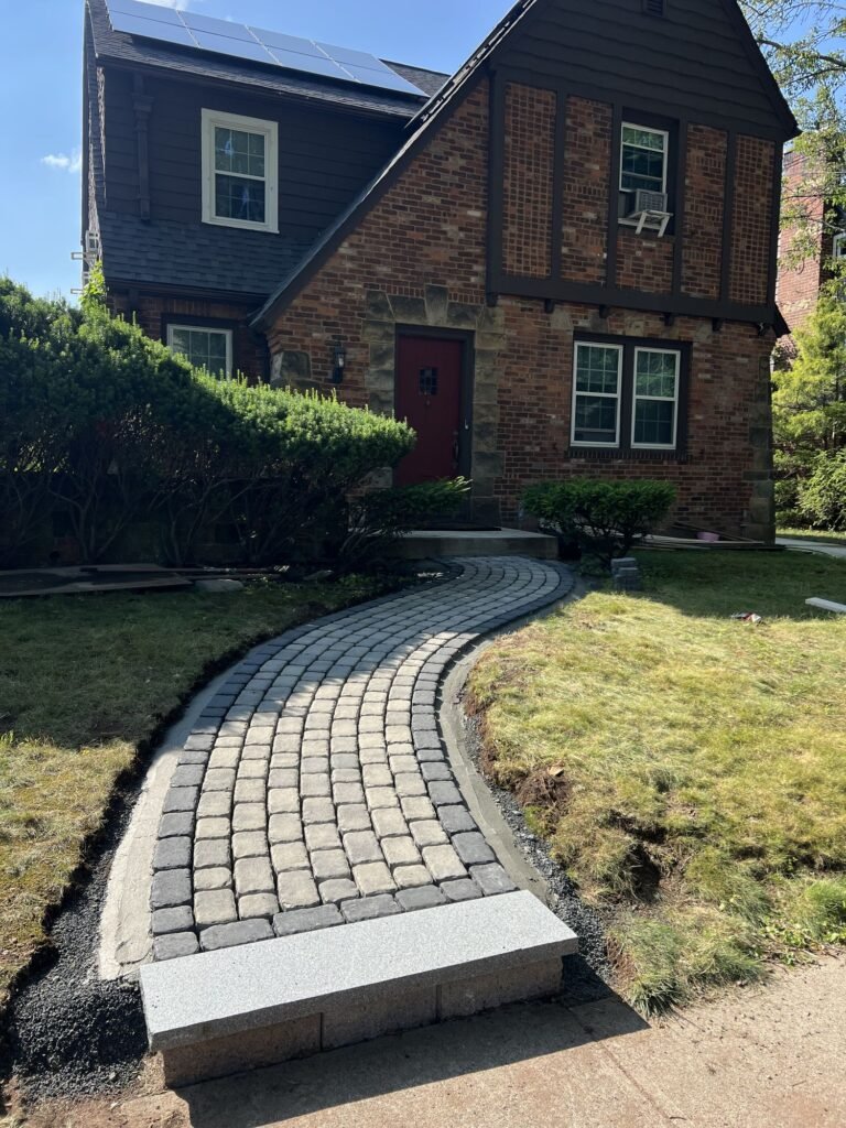 After: curved cobblestone-style paver walkway with a stone step in New Haven, CT