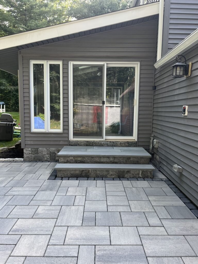 Large-format slab patio with bluestone steps in Simsbury, CT