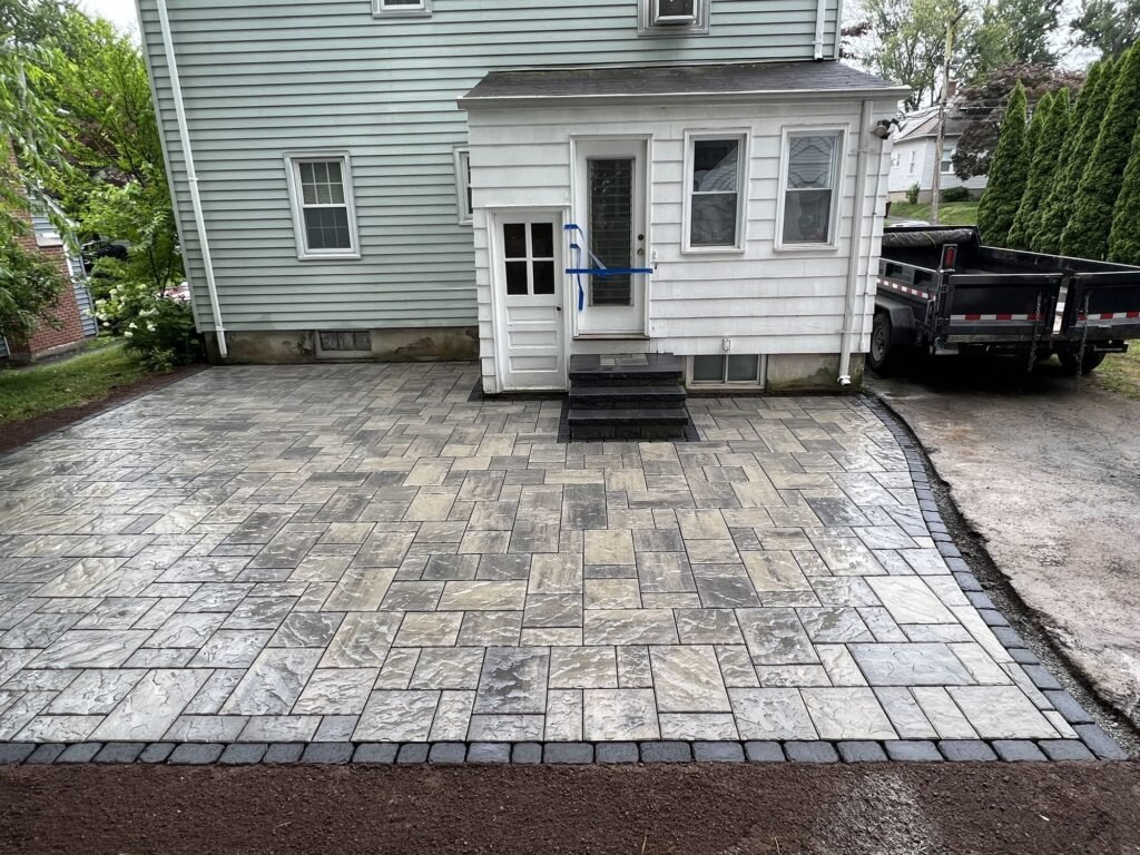Backyard paver patio with a contrasting border in West Hartford, CT