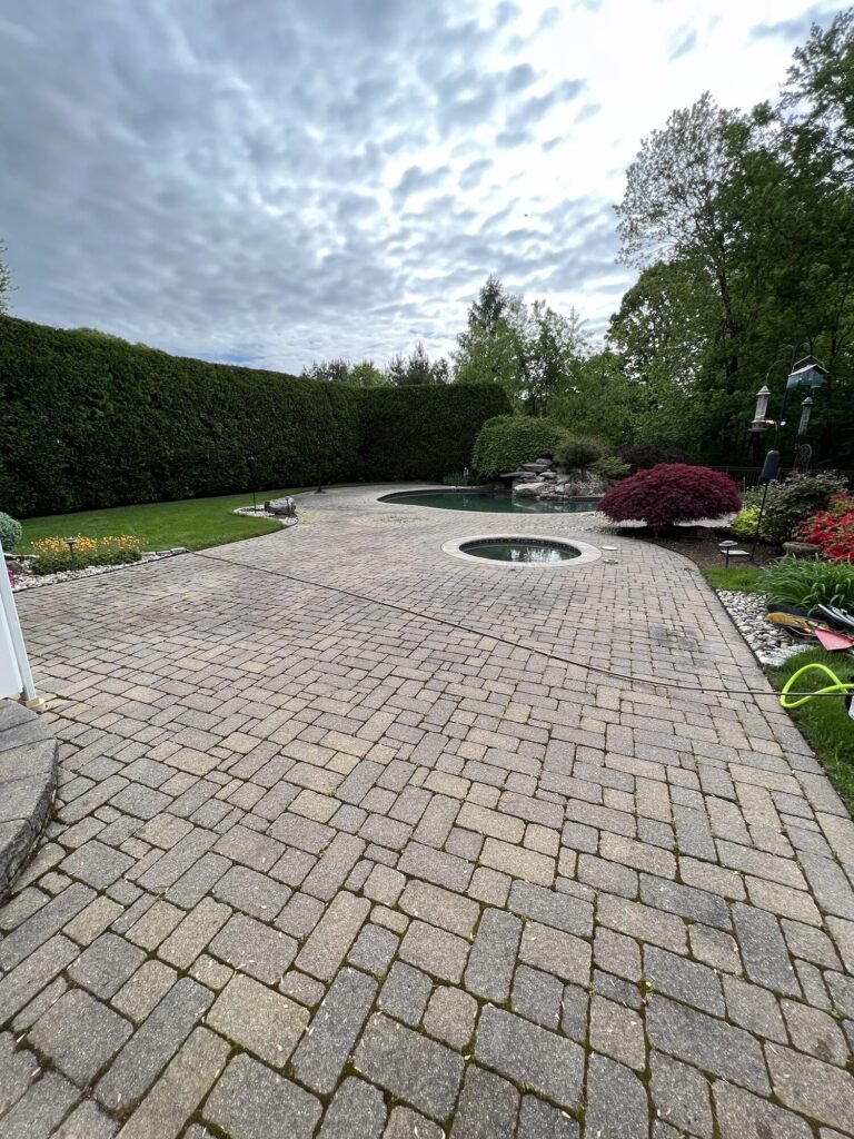 Before: weathered paver pool patio before cleaning