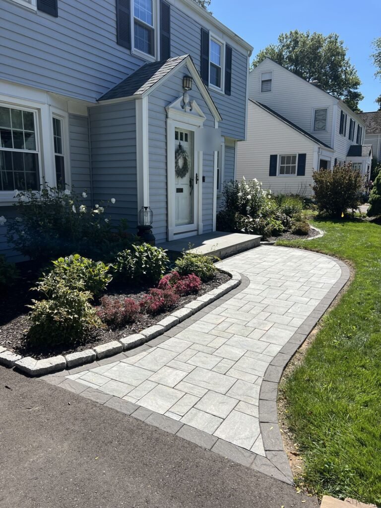Curved paver front walkway with a border in West Hartford, CT