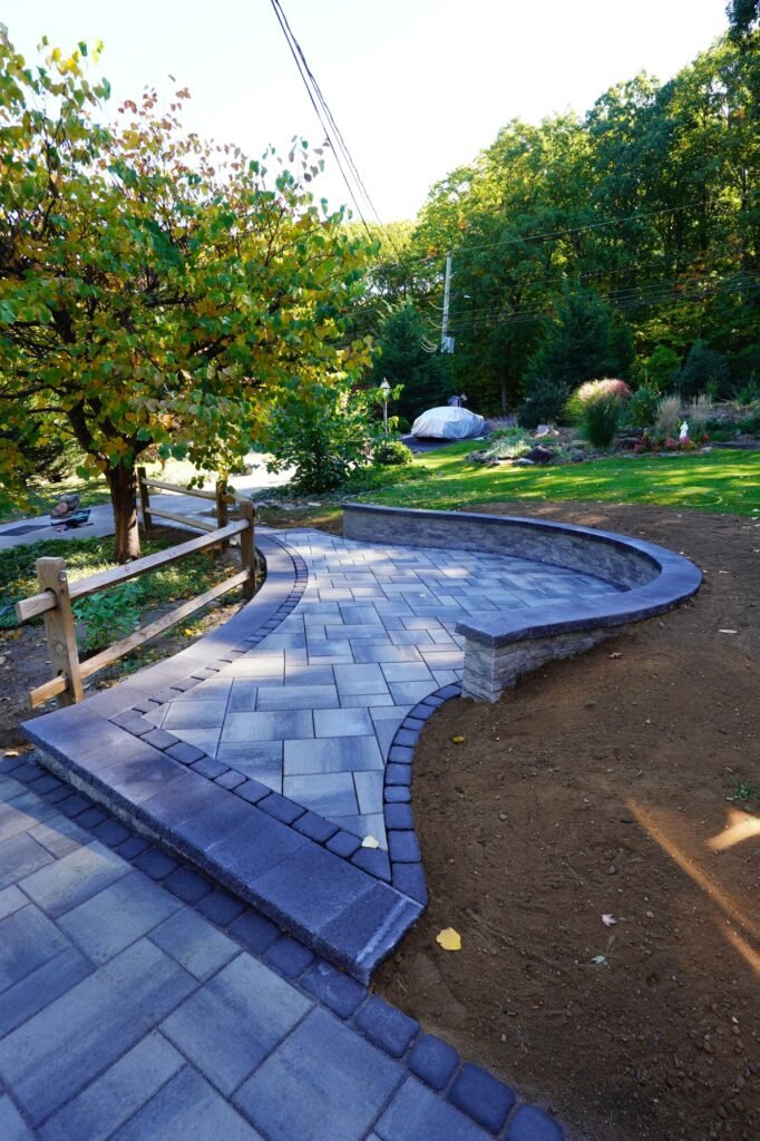 Curved paver walkway with a seat wall