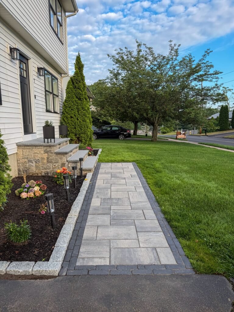 Paver front walkway with a granite cobblestone edge