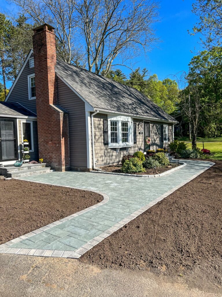 Paver front walkway and steps on a Cape-style home