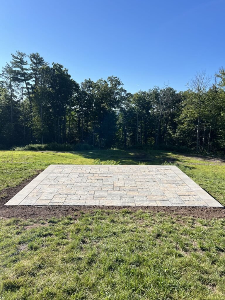 New paver patio in an open backyard in Canton, CT
