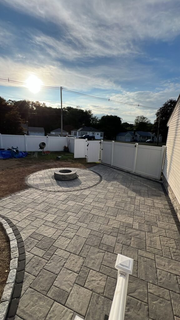 Paver patio with a fire pit circle and a border in Wallingford, CT