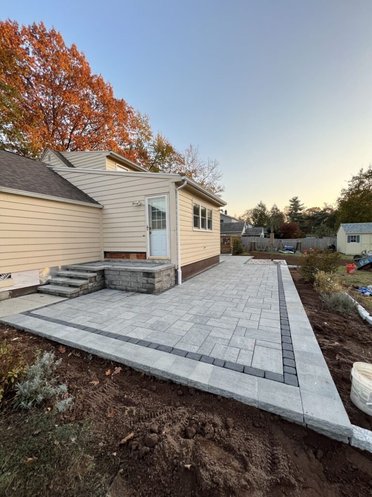 Paver patio with a contrasting soldier-course border in North Haven, CT