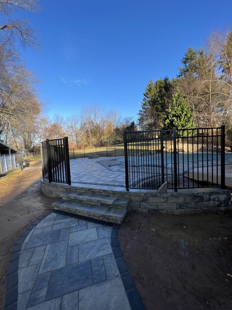 Paver steps and walkway leading to a pool patio in Cheshire, CT
