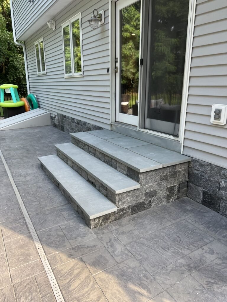 Stone veneer steps with bluestone treads off a back door in Southington, CT